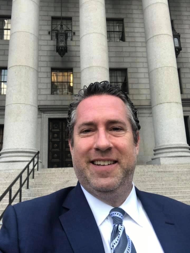 Ken Litman in front of government building.