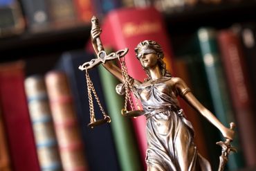 Lady Justice statue with law books.